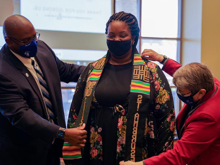 student fitted with cultural stole